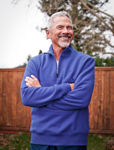 Michael G in a blue sweater with crossed arms